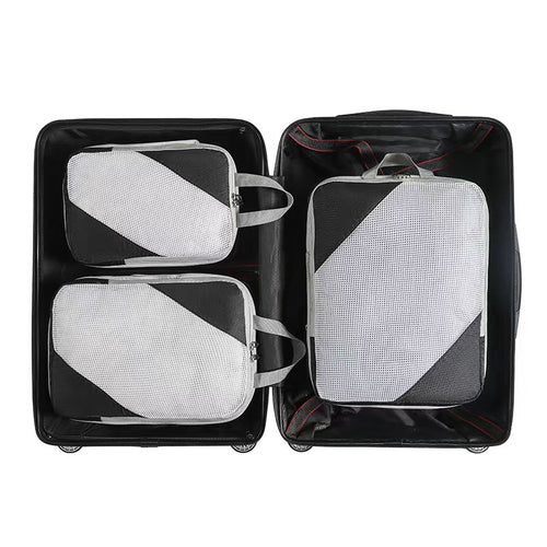 Three black packing cubes with mesh panels arranged in an open suitcase; suitcase not included.
