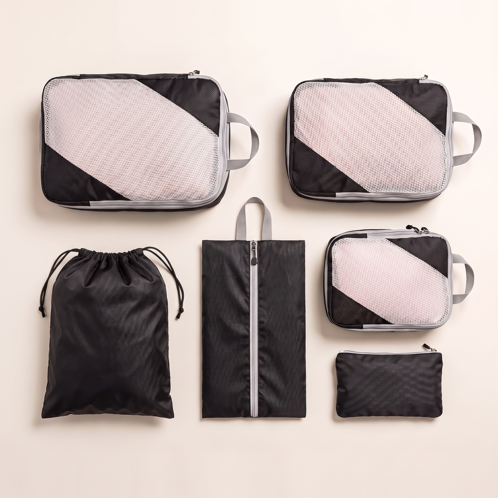 AI-generated illustration of three black packing cubes and three accessory organizers on a light background.